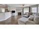 Comfortable living room with fireplace adjacent to a kitchen and sliding doors to an outdoor patio at 3320 Haven Beach Way, Las Vegas, NV 89117
