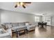 Spacious open-concept living room with dining area and comfortable gray sectional couch at 3320 Haven Beach Way, Las Vegas, NV 89117
