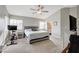 Airy main bedroom featuring natural light, a TV, and an attached bathroom at 3320 Haven Beach Way, Las Vegas, NV 89117