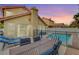 Backyard patio with dining table and chairs, adjacent to the pool at 3320 Haven Beach Way, Las Vegas, NV 89117