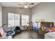 Bright playroom with a ceiling fan, two large windows, and plenty of space for activities at 3320 Haven Beach Way, Las Vegas, NV 89117