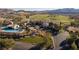 Elevated view of the community clubhouse, pool, and manicured grounds against a mountain backdrop at 37 Reflection Shores Ln, Henderson, NV 89011