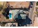 Aerial view of a modern home with a sparkling pool, desert landscaping, and a neatly paved driveway at 37 Reflection Shores Ln, Henderson, NV 89011