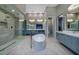 Bright bathroom features a freestanding tub, dual sinks, and a glass enclosed shower at 37 Reflection Shores Ln, Henderson, NV 89011