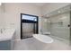 Elegant bathroom features a freestanding tub, glass shower and outdoor access at 37 Reflection Shores Ln, Henderson, NV 89011