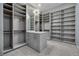 Spacious walk-in closet with custom shelving, drawers, mirror, and modern lighting at 37 Reflection Shores Ln, Henderson, NV 89011