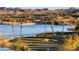 Picturesque view of the golf course and lake with palm trees at 37 Reflection Shores Ln, Henderson, NV 89011