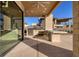 A stainless steel grill, pizza oven, refrigerator and bar is part of this home's outdoor kitchen at 37 Reflection Shores Ln, Henderson, NV 89011