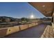 Expansive covered patio with ceiling fans overlooking a golf course and mountain views on a sunny day at 37 Reflection Shores Ln, Henderson, NV 89011