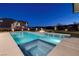 Stunning backyard pool and spa area with water feature, fire pit, and views of the city lights at twilight at 37 Reflection Shores Ln, Henderson, NV 89011