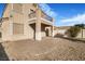 Home's backyard features a patio and gravel landscaping at 3817 Bella Legato Ave, North Las Vegas, NV 89081