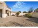 Large backyard with gravel and a paved patio, offering ample outdoor space at 3817 Bella Legato Ave, North Las Vegas, NV 89081