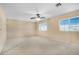 Well-lit bedroom featuring a ceiling fan and two windows at 3817 Bella Legato Ave, North Las Vegas, NV 89081