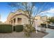 Two-story house with tan exterior, landscaping, and a two-car garage at 3817 Bella Legato Ave, North Las Vegas, NV 89081