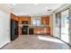 Kitchen with wood cabinets, black appliances, and tile floors at 3817 Bella Legato Ave, North Las Vegas, NV 89081