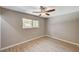 Spacious bedroom with ceiling fan and window at 3834 S Sandhill Rd, Las Vegas, NV 89121