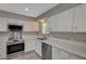 Modern kitchen with white cabinets and stainless steel appliances at 3834 S Sandhill Rd, Las Vegas, NV 89121