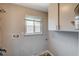 Laundry room with overhead cabinets and window at 3834 S Sandhill Rd, Las Vegas, NV 89121