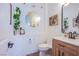 Stylish powder room with a round mirror and modern vanity at 5378 Pendini Point Ct, Las Vegas, NV 89141