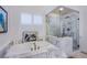 Elegant bathroom with soaking tub, marble shower, and modern fixtures at 5378 Pendini Point Ct, Las Vegas, NV 89141