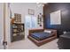 Stylish bedroom with a brown platform bed and dark wall at 5378 Pendini Point Ct, Las Vegas, NV 89141