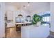 Bright white kitchen with island, stainless steel appliances, and ample storage at 5378 Pendini Point Ct, Las Vegas, NV 89141