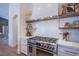 Stainless steel range and oven with white shaker cabinets and quartz countertops at 5378 Pendini Point Ct, Las Vegas, NV 89141