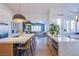 Modern kitchen with white cabinets, quartz countertops, and a large island with seating at 5378 Pendini Point Ct, Las Vegas, NV 89141