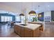 Modern kitchen island with white countertops and wooden cabinets at 5378 Pendini Point Ct, Las Vegas, NV 89141