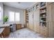 Home office with built-in desk, shelving and window with plantation shutters at 5378 Pendini Point Ct, Las Vegas, NV 89141