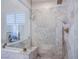 Large walk-in shower with marble tile and built-in seat at 5378 Pendini Point Ct, Las Vegas, NV 89141