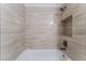 Modern bathroom with a bathtub and sleek, light brown tile at 6750 Del Rey Ave # 122, Las Vegas, NV 89146