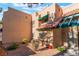 Tan stucco townhouse with green accents and desert landscaping at 6750 Del Rey Ave # 122, Las Vegas, NV 89146