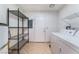 Laundry room with washer, dryer, shelving, and exterior access at 6750 Del Rey Ave # 122, Las Vegas, NV 89146