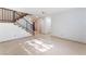 Bright living room with tile floors and wooden staircase at 6750 Del Rey Ave # 122, Las Vegas, NV 89146