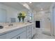 Double vanity bathroom with large shower and marble floor at 6942 Alexandrite Peak St, Las Vegas, NV 89148