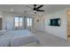 Large bedroom with king-size bed, ceiling fan, and access to balcony at 6942 Alexandrite Peak St, Las Vegas, NV 89148