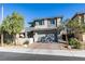 Two-story home with gray exterior, two-car garage, and landscaped yard at 6942 Alexandrite Peak St, Las Vegas, NV 89148