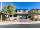 Two-story home with gray exterior, two-car garage, and landscaped yard at 6942 Alexandrite Peak St, Las Vegas, NV 89148