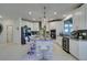 Modern kitchen with granite island, stainless steel appliances, and white cabinets at 6942 Alexandrite Peak St, Las Vegas, NV 89148