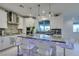 Modern kitchen with granite counters, stainless steel appliances, and an island at 6942 Alexandrite Peak St, Las Vegas, NV 89148