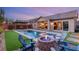 Luxury backyard with pool, fire pit, and comfortable seating area at 7563 Saguaro Cactus Ave, Las Vegas, NV 89178