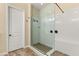 Large walk-in shower with hexagon tile flooring and built-in seat at 7563 Saguaro Cactus Ave, Las Vegas, NV 89178