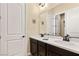 Double vanity bathroom with dark brown cabinets and a quartz countertop at 7563 Saguaro Cactus Ave, Las Vegas, NV 89178