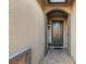 Elegant entryway with dark brown door and tile flooring at 7563 Saguaro Cactus Ave, Las Vegas, NV 89178