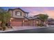 Two-story house with attached garage, landscaping and driveway at 7563 Saguaro Cactus Ave, Las Vegas, NV 89178