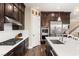 Modern kitchen with dark wood cabinets and a large island at 7563 Saguaro Cactus Ave, Las Vegas, NV 89178