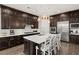 Gourmet kitchen features dark cabinetry, white backsplash, and island at 7563 Saguaro Cactus Ave, Las Vegas, NV 89178