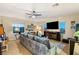 Relaxing living room featuring a large sectional sofa and TV at 7563 Saguaro Cactus Ave, Las Vegas, NV 89178