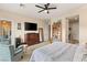 Main bedroom with large TV and sitting area at 7563 Saguaro Cactus Ave, Las Vegas, NV 89178